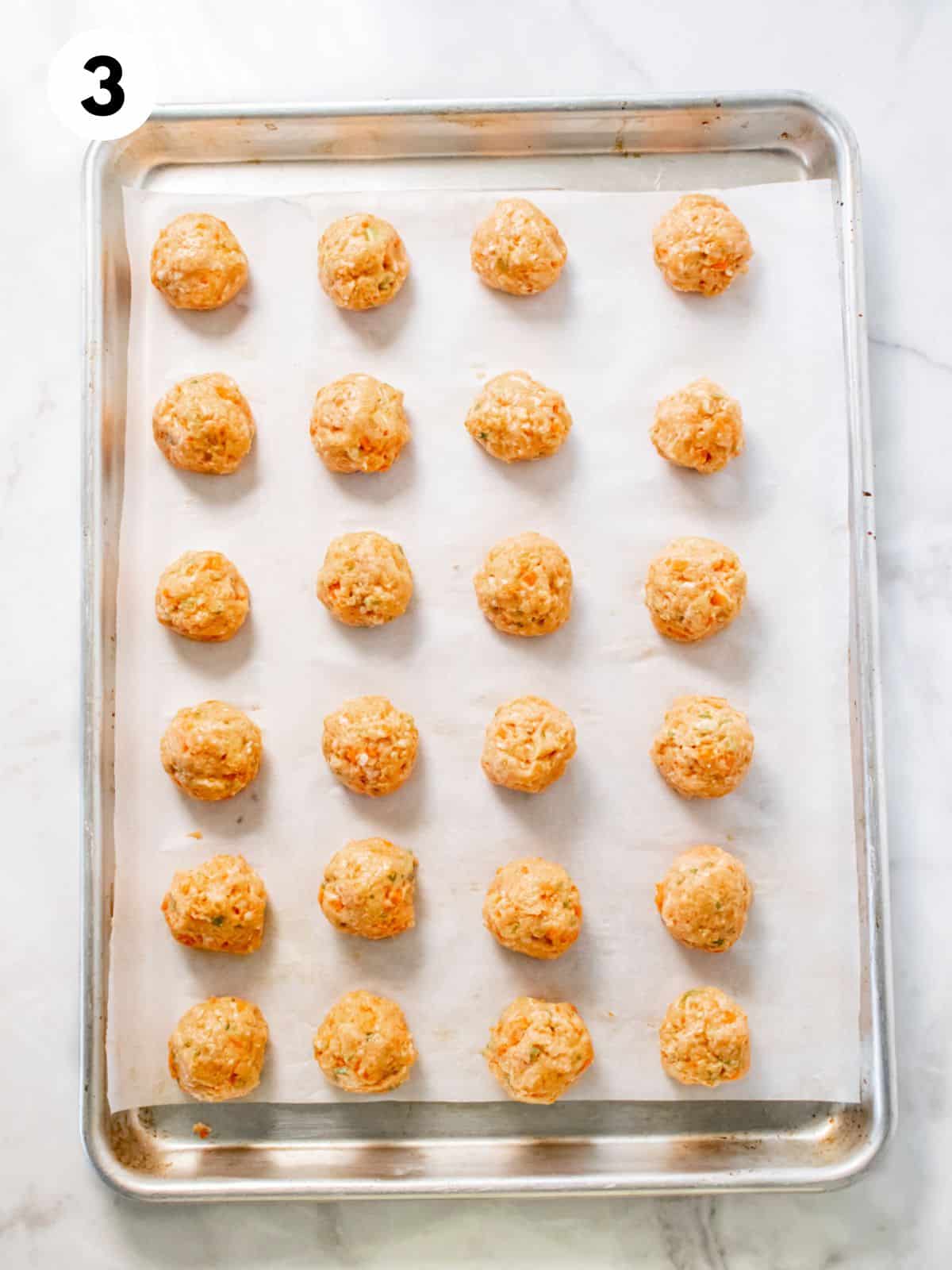 Buffalo chicken meatballs on a baking tray.
