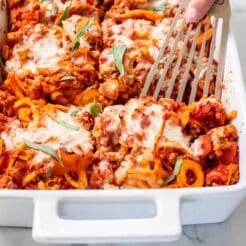 A spatula scooping up a serving of ground turkey casserole from the dish.