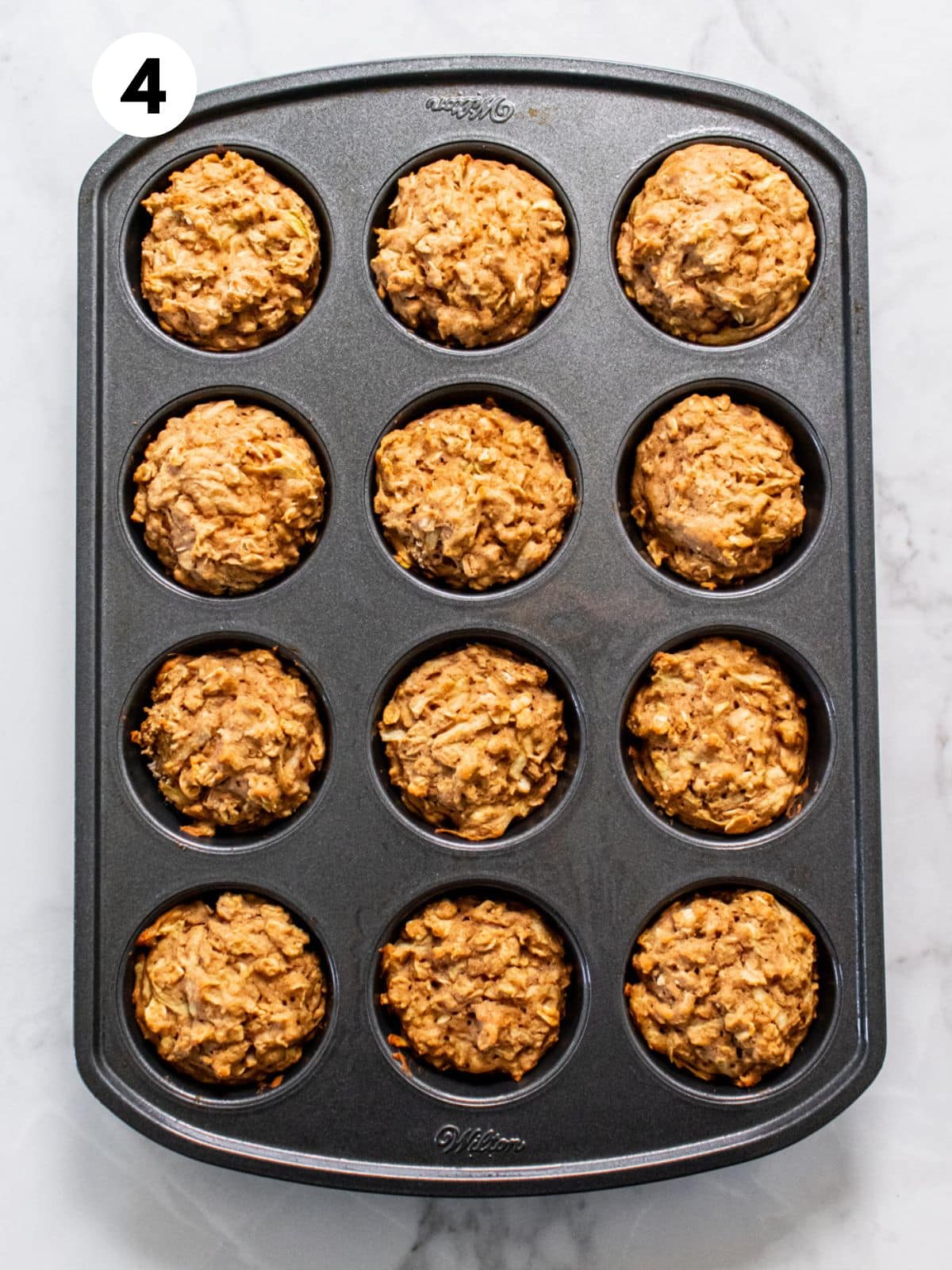 Baked healthy apple muffins in the pan after cooking.