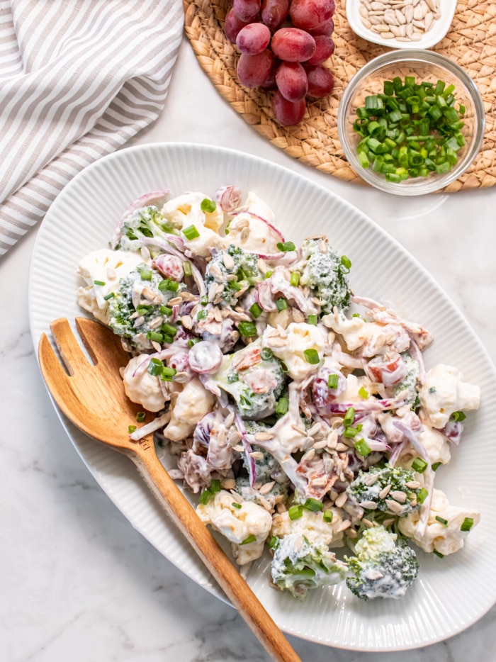 The Best Low Calorie Bacon Broccoli Cauliflower Salad! Made with no mayo, this easy side dish is warm, packed with delicious flavors and quick to make.