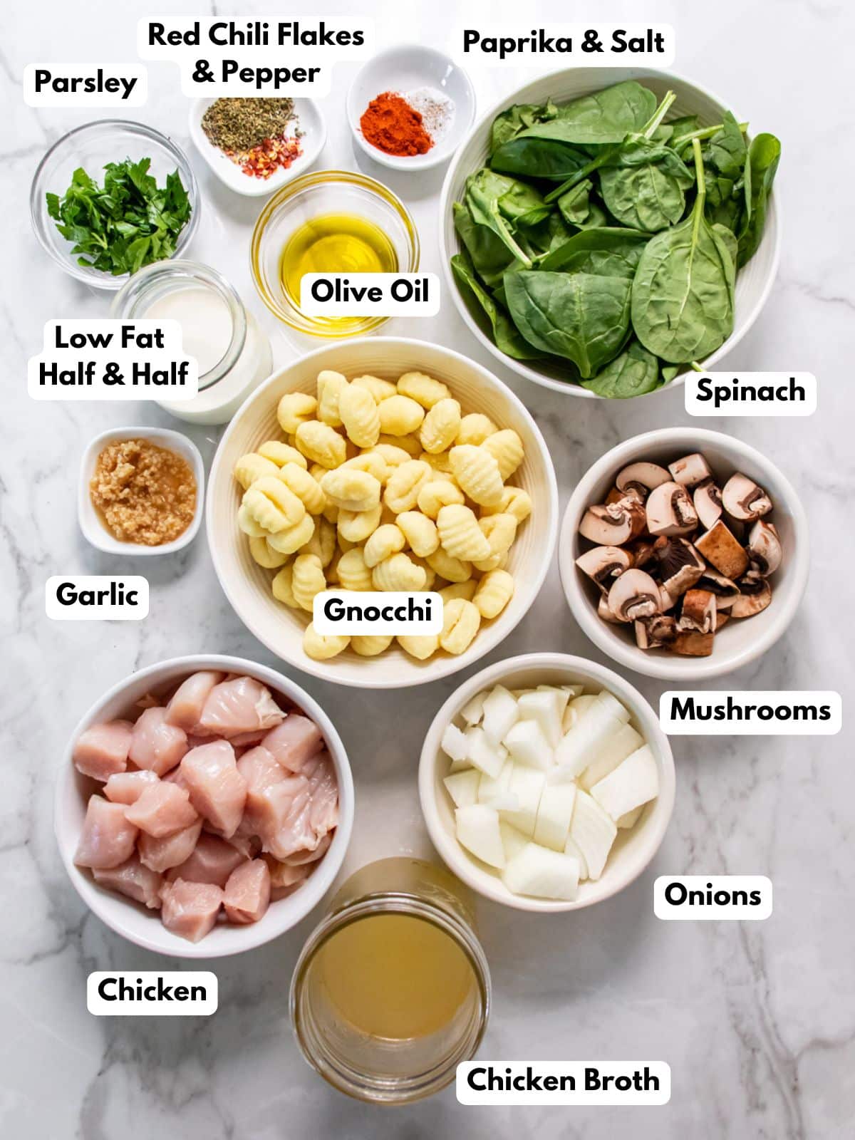 Ingredients for healthy chicken gnocchi on a counter in bowls.