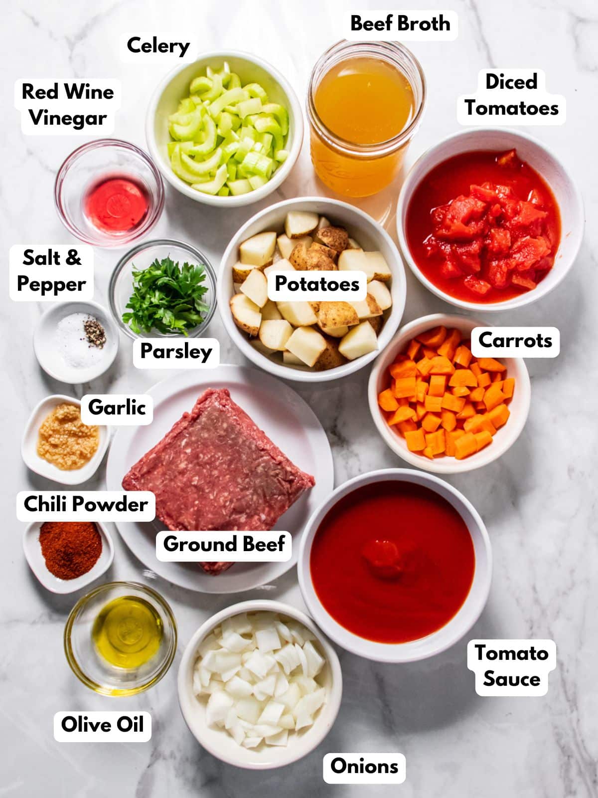 ingredients for healthy beef vegetable soup on the table in white bowls.