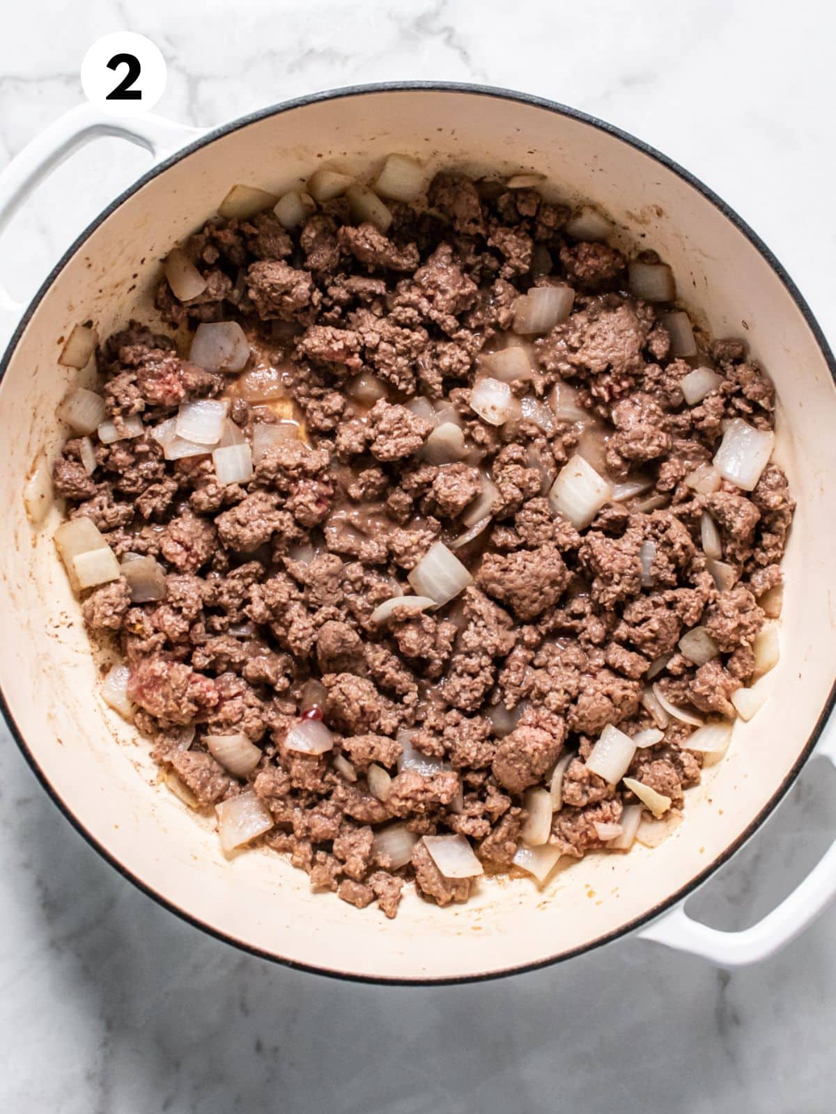 Ground beef added to the onions and browned.