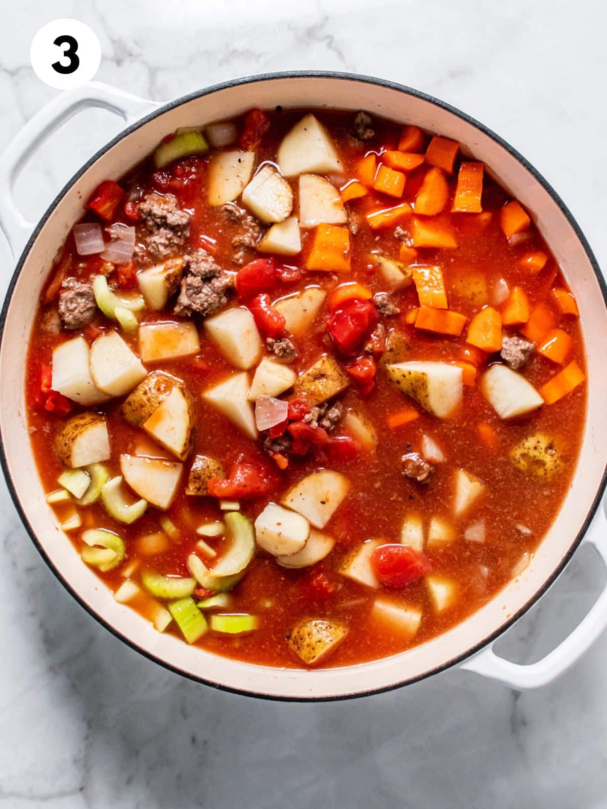 Vegetable beef soup ingredients all added to the pot.