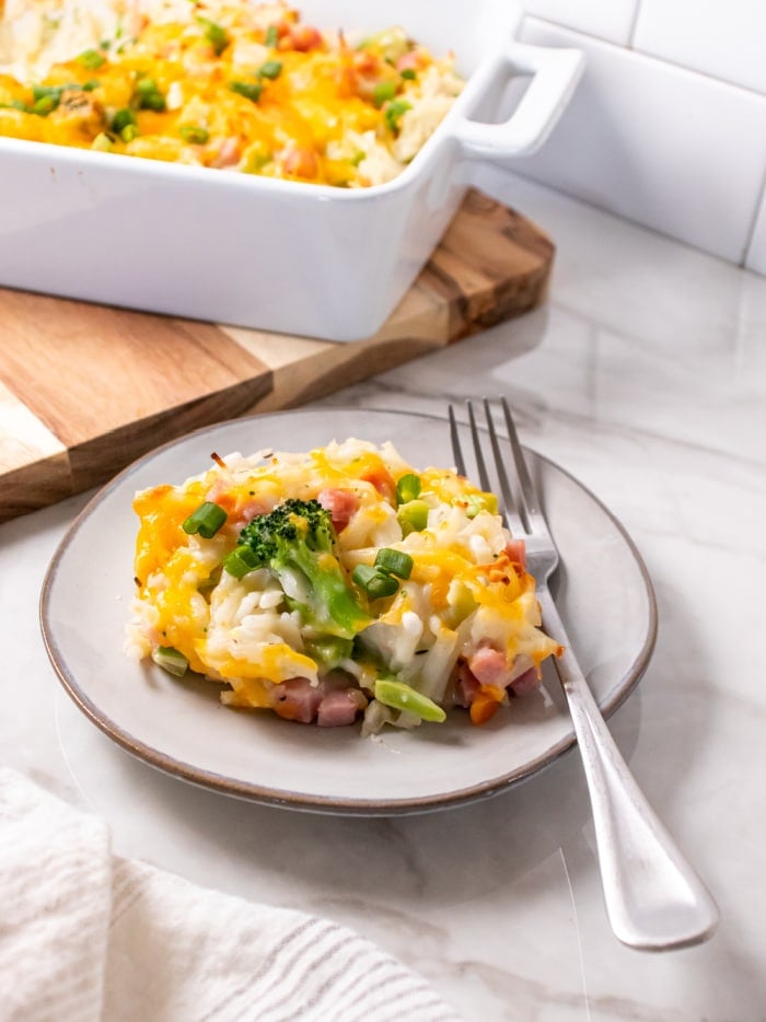 Healthy Ham and Potato Casserole is a low calorie casserole made with frozen shredded potatoes for ease loaded with broccoli and topped with a creamy cheese sauce!