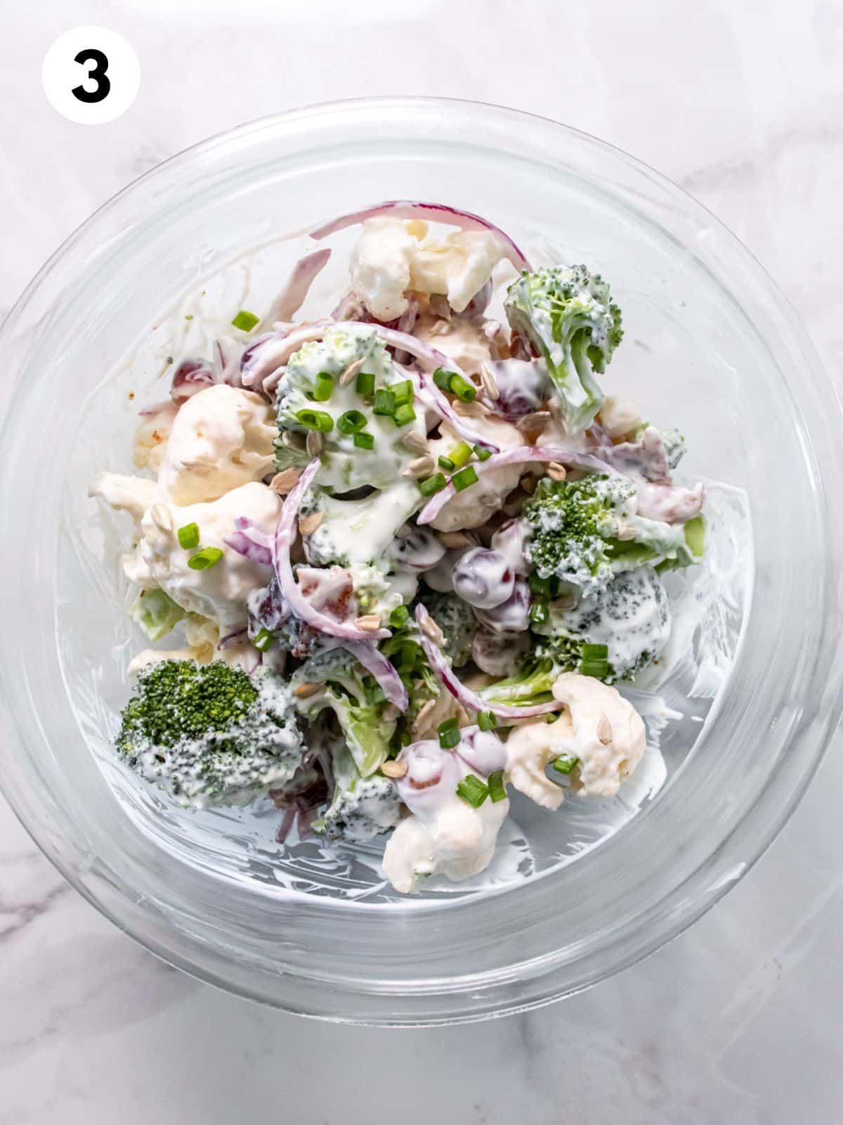 Broccoli and cauliflower salad mixed in a bowl.