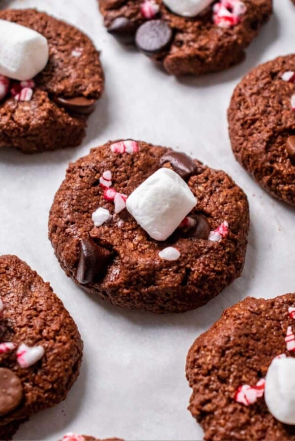 Peppermint hot chocolate cookies baked on a pan topped with a marshmallow.