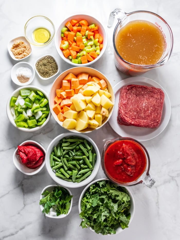 bowls and plates of ingredients measured to make healthy hamburger soup recipe