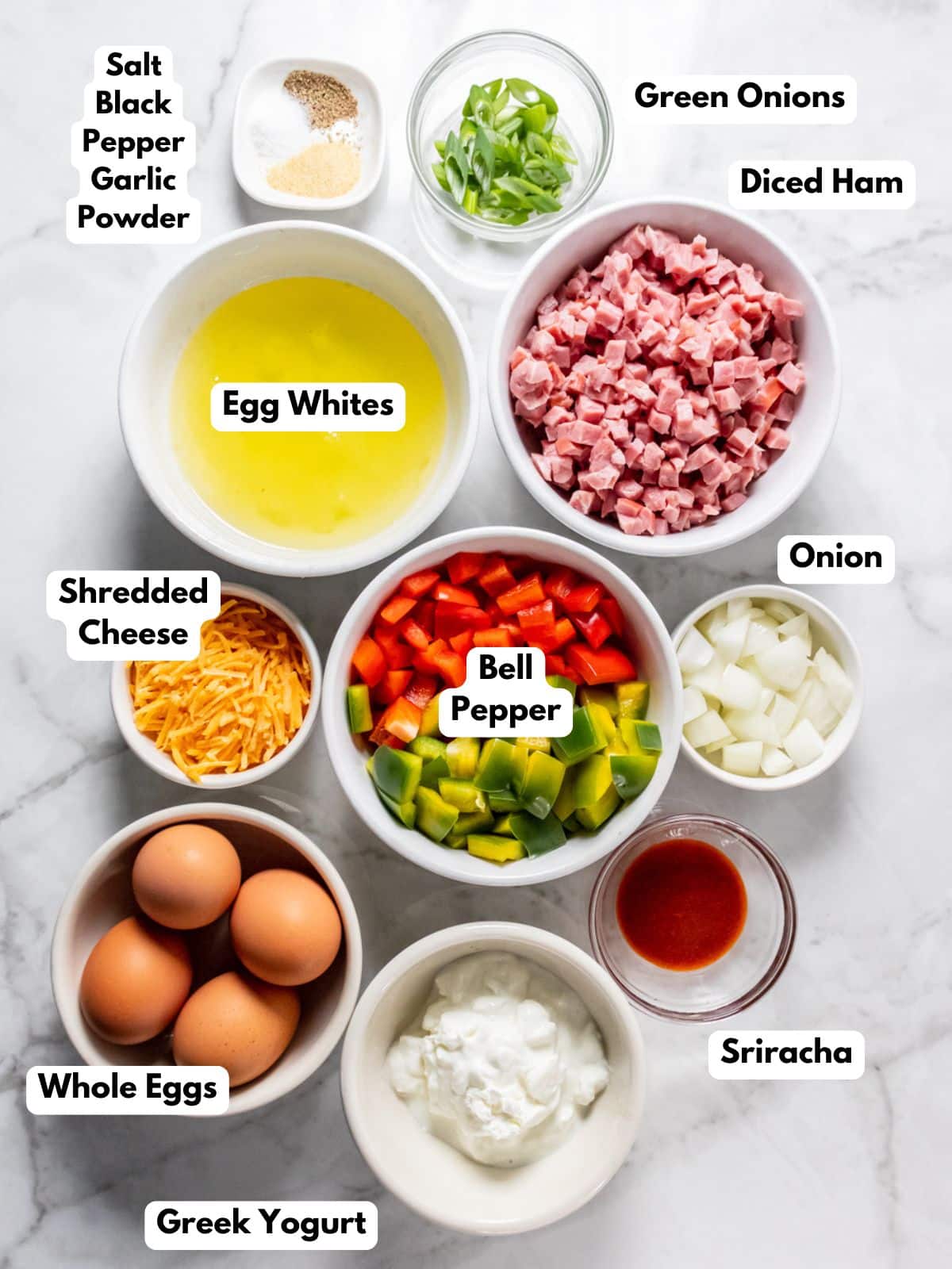 White bowls of food on a white counter with text labels to the side to identify each ingredient in the recipe.