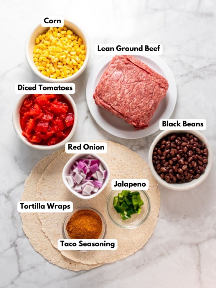 Ingredients to make high protein burritos on a table in bowls.