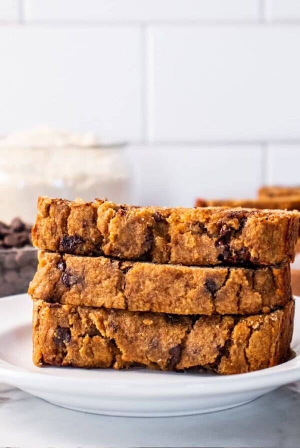 Three slices of coconut flour banana bread on a plate.