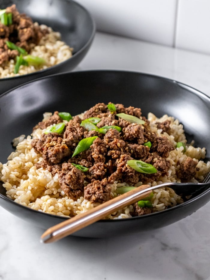 brown rice topped with ground beef in a bowl