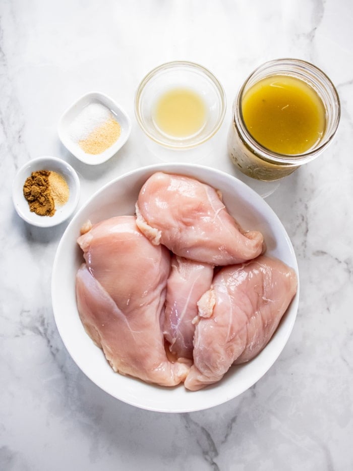 raw chicken breast in a white bowl