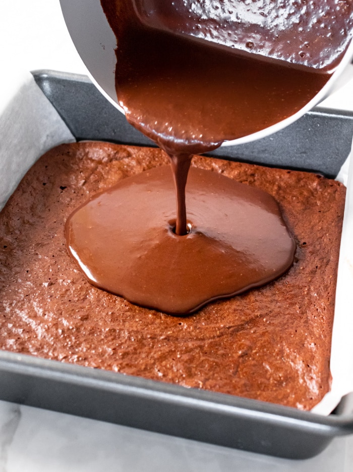 chocolate ganache pour over a pan of brownies