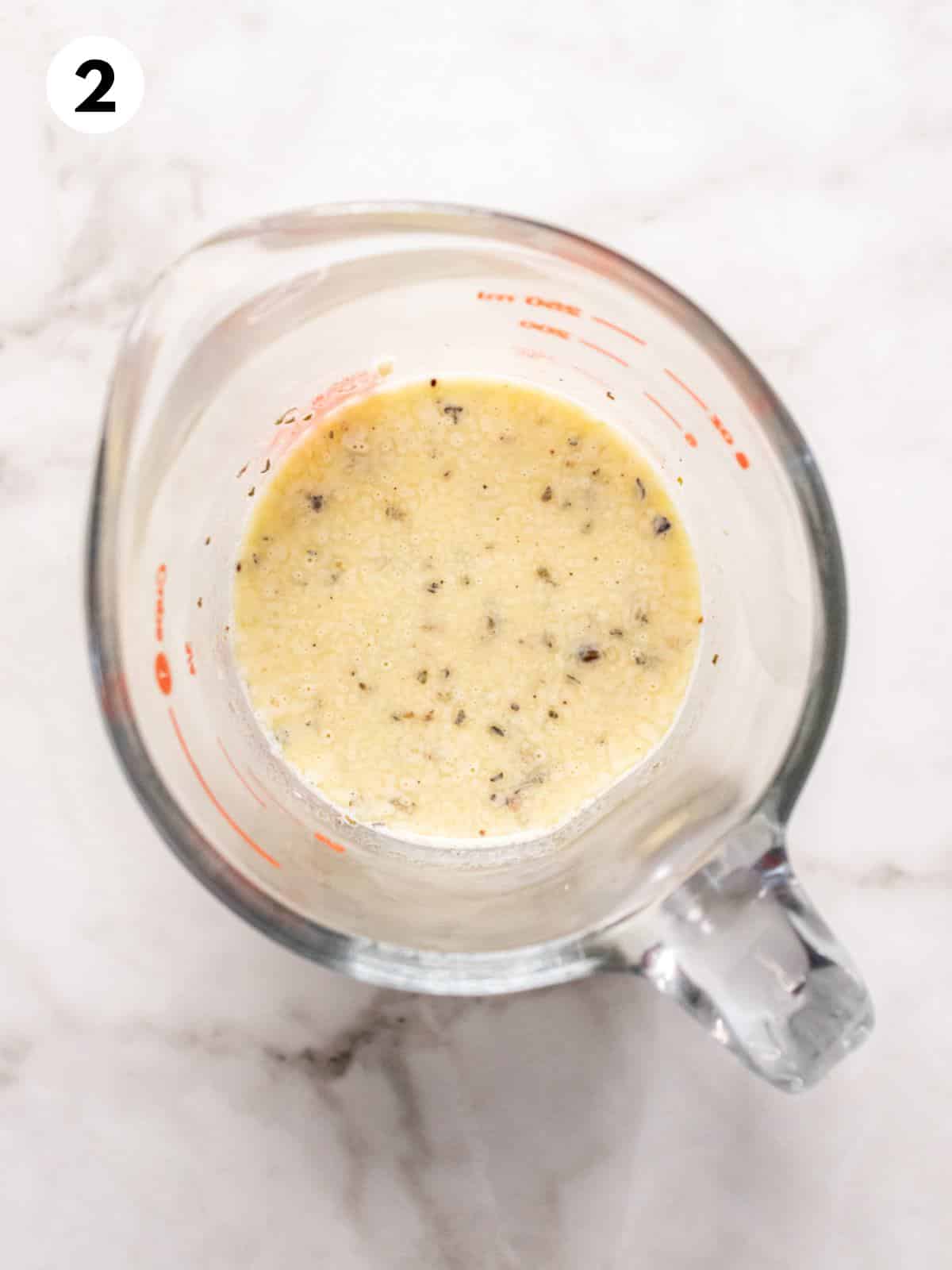 Low calorie Olive Garden salad dressing in a measuring cup.