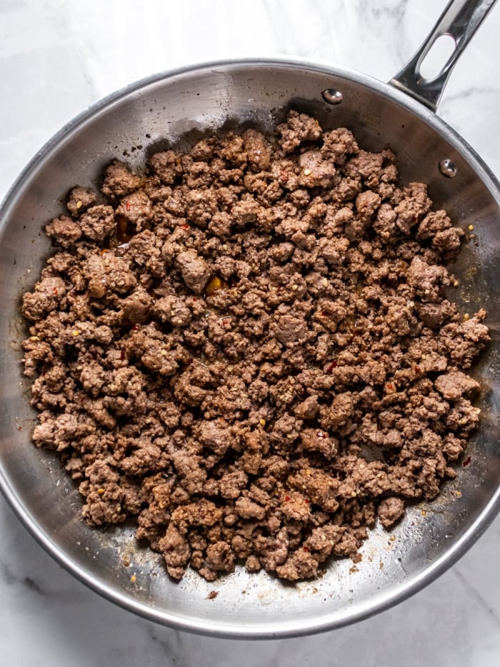 ground beef cooked in a silver pan