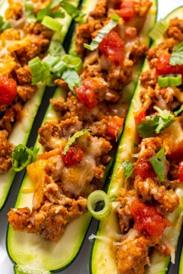 Zucchini taco boats topped with cheese.