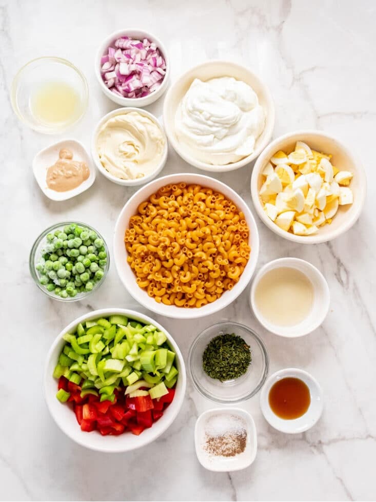 macaroni salad ingredients in white bowls
