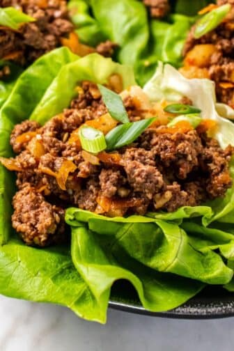 Ground beef lettuce wrap on a platter with more in the background.