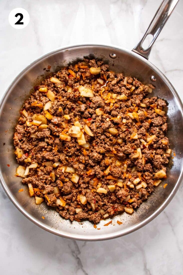 Ingredients added to the cooked ground beef in the skillet.