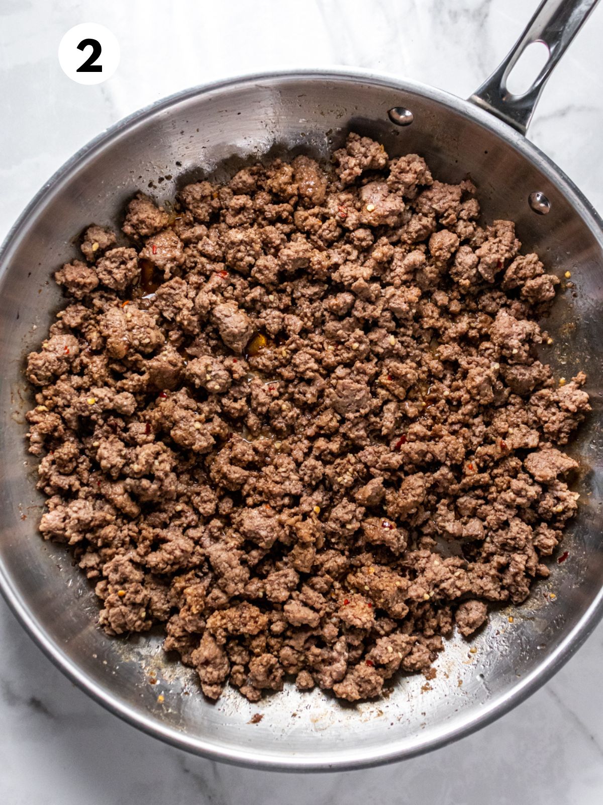 Seasonings added to the skillet with the groudn beef.