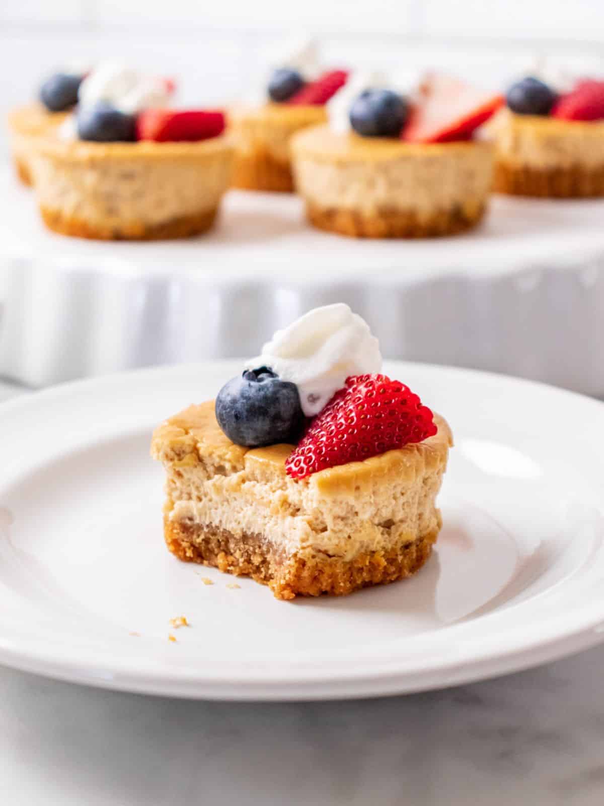 A Mini Protein Cheesecake on a plate with a bite missing.  