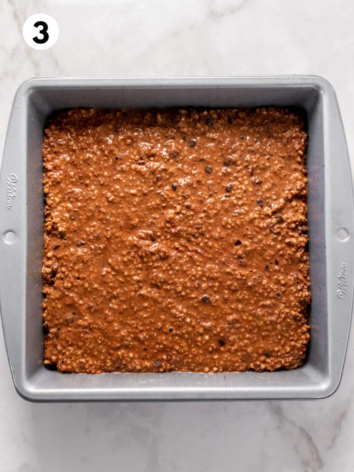 Quinoa brownie mixture poured into a pan.