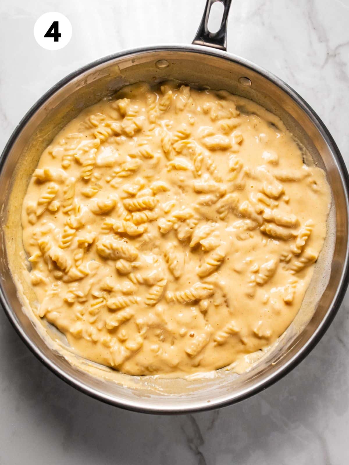 Pasta with cheese cooked in a skillet.