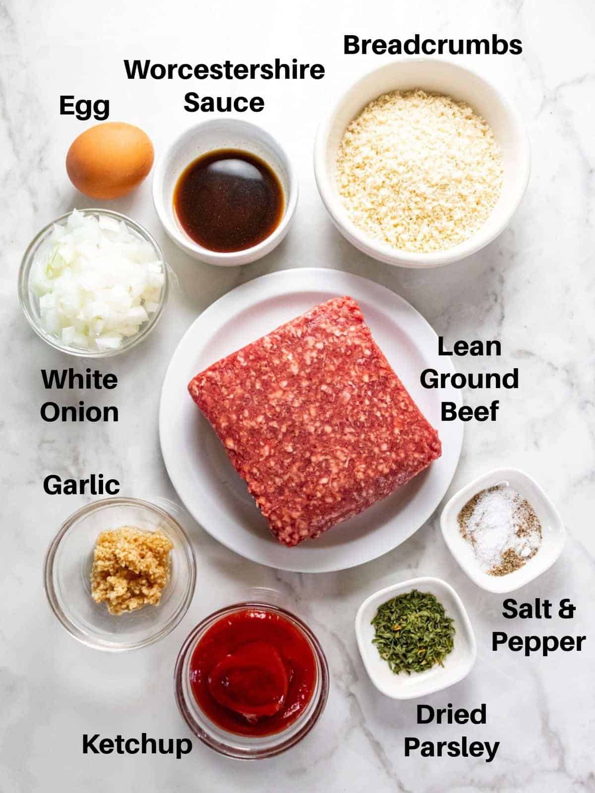 Ingredients needed to make a 1 lb meatloaf on the table before mixing.