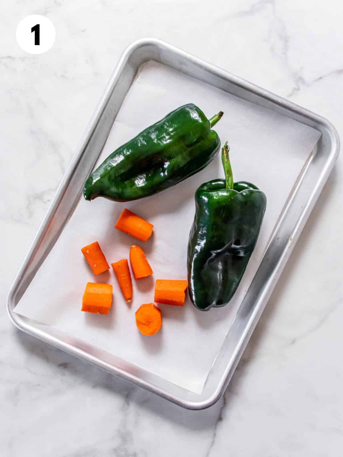Chilies and vegetables to make healthy tortilla soup on a baking pan.
