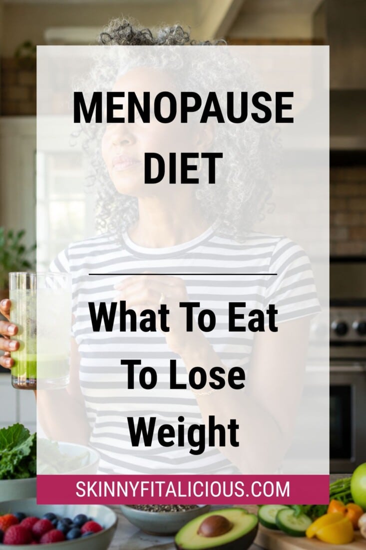 Woman holding a green smoothie in a kitchen with fresh fruits and vegetables on the counter, representing a menopause diet.