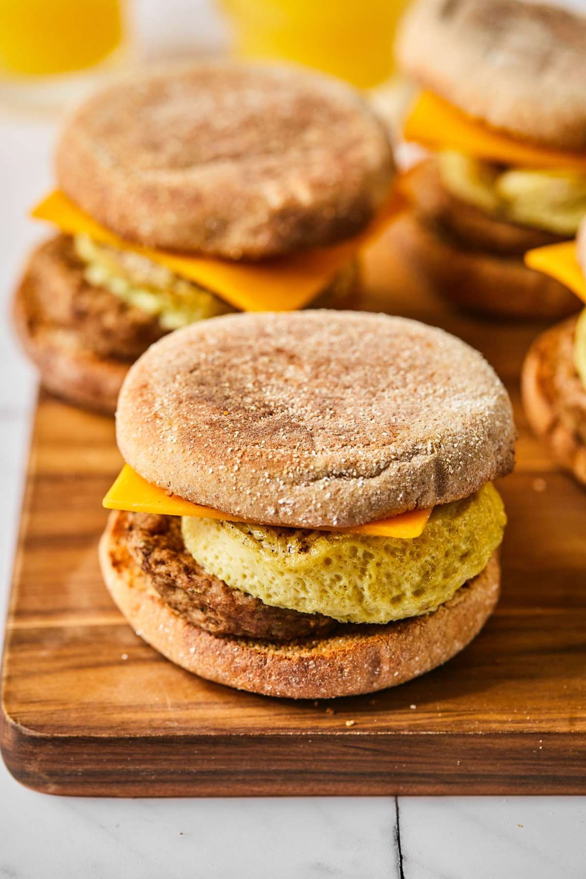 Finished healthy breakfast sandwiches on a wooden cutting board.