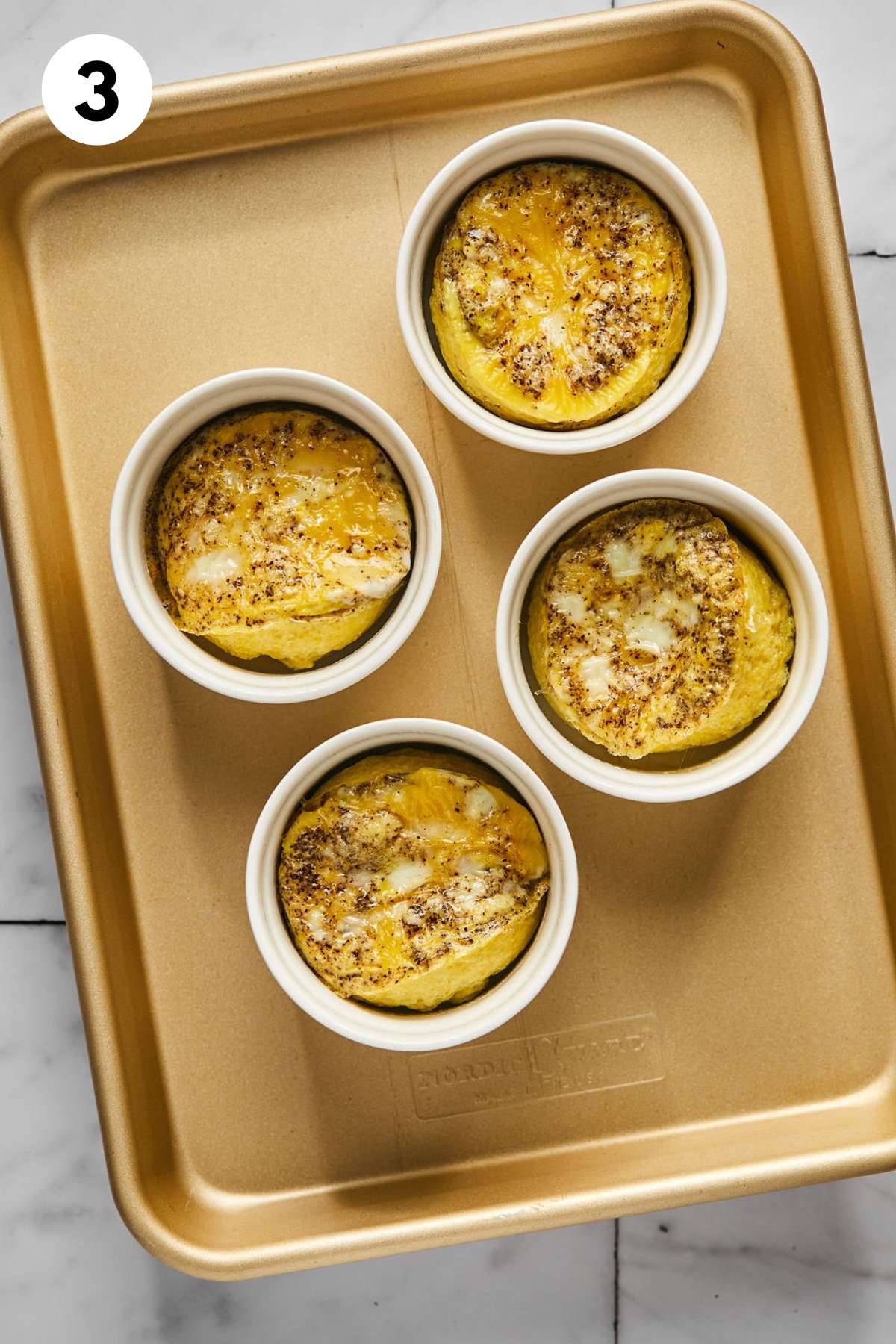 Baked egg cups on a baking pan.