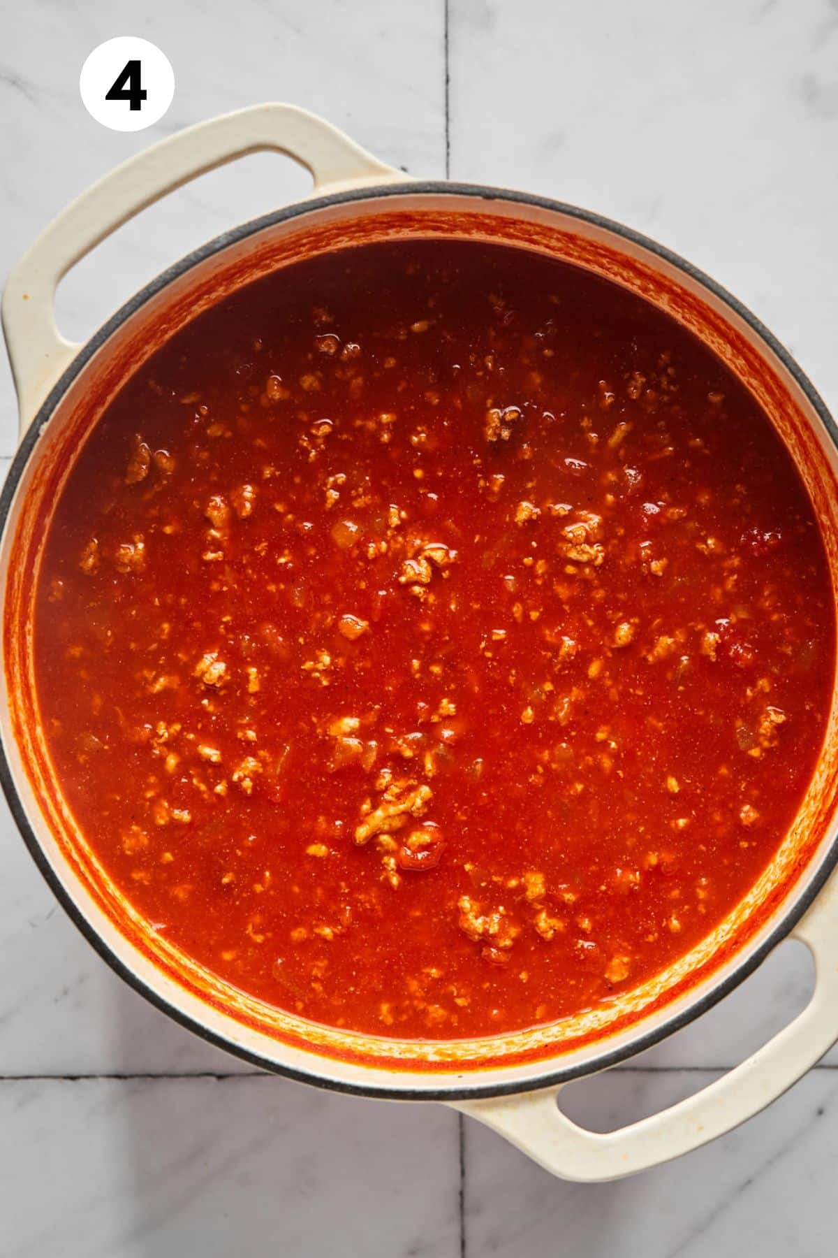 Tomatoes and broth added to the pot.