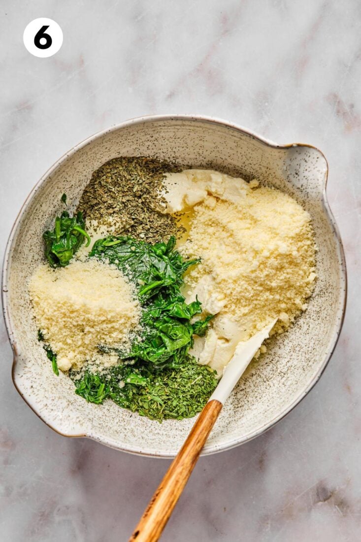 Spinach pesto cheese filling for high protein vegetarian lasagna in  mixing bowl.