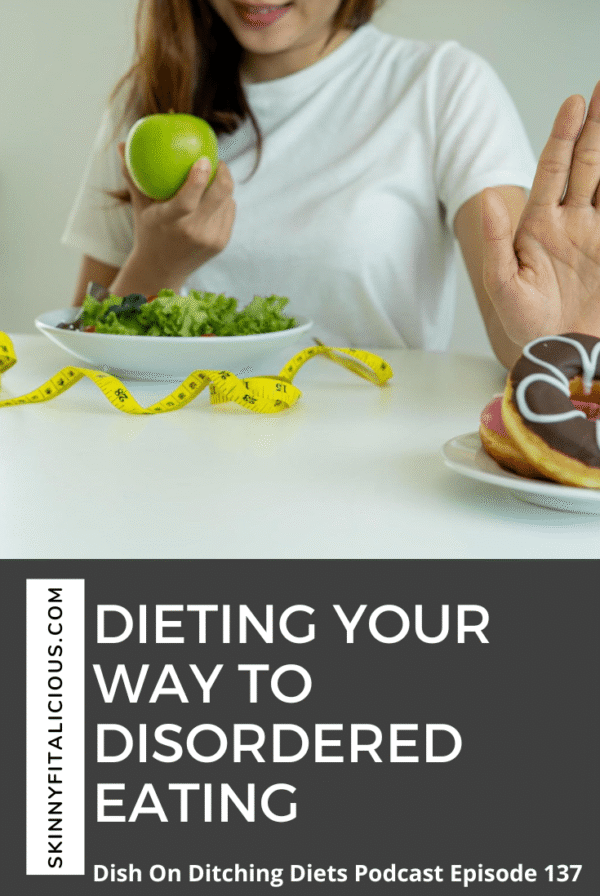 woman in a white t-shirt with a green apple pushing a donut away.