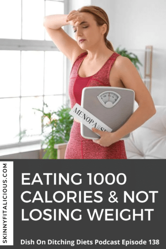 woman in a pink tank top holding a scale with a menopause sign.