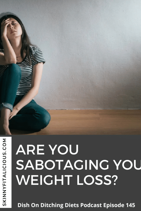 woman sitting on floor in jean frustrated with her hand on her face.