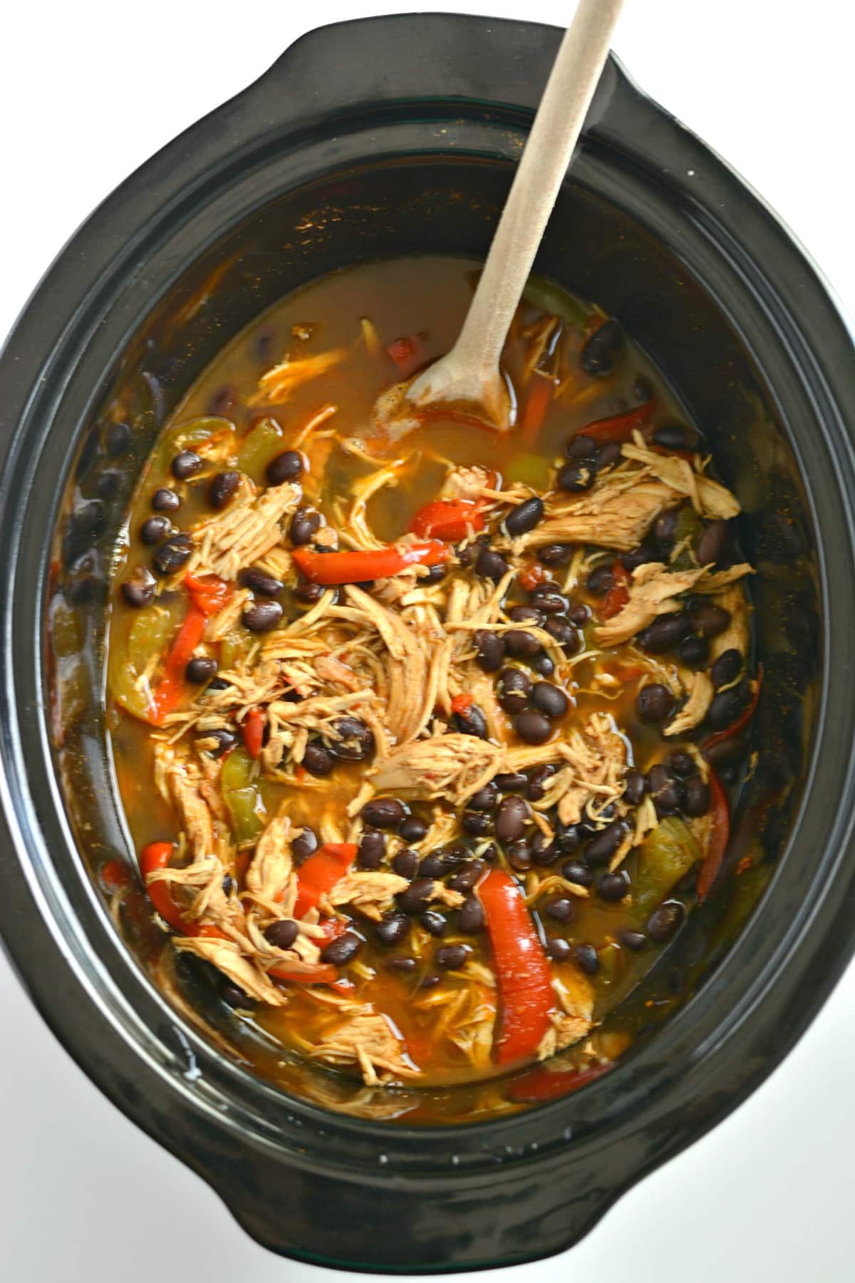 shredded chicken with bell peppers and black beans in a slow cooker