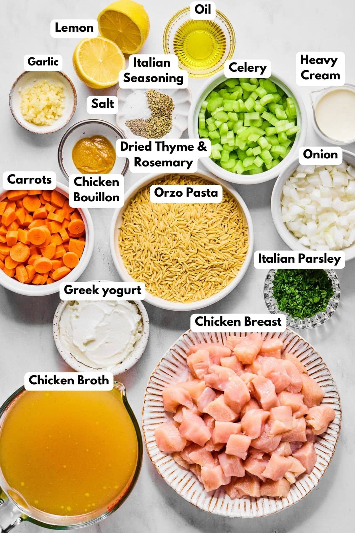 Ingredients for making chicken orzo soup in bowls.
