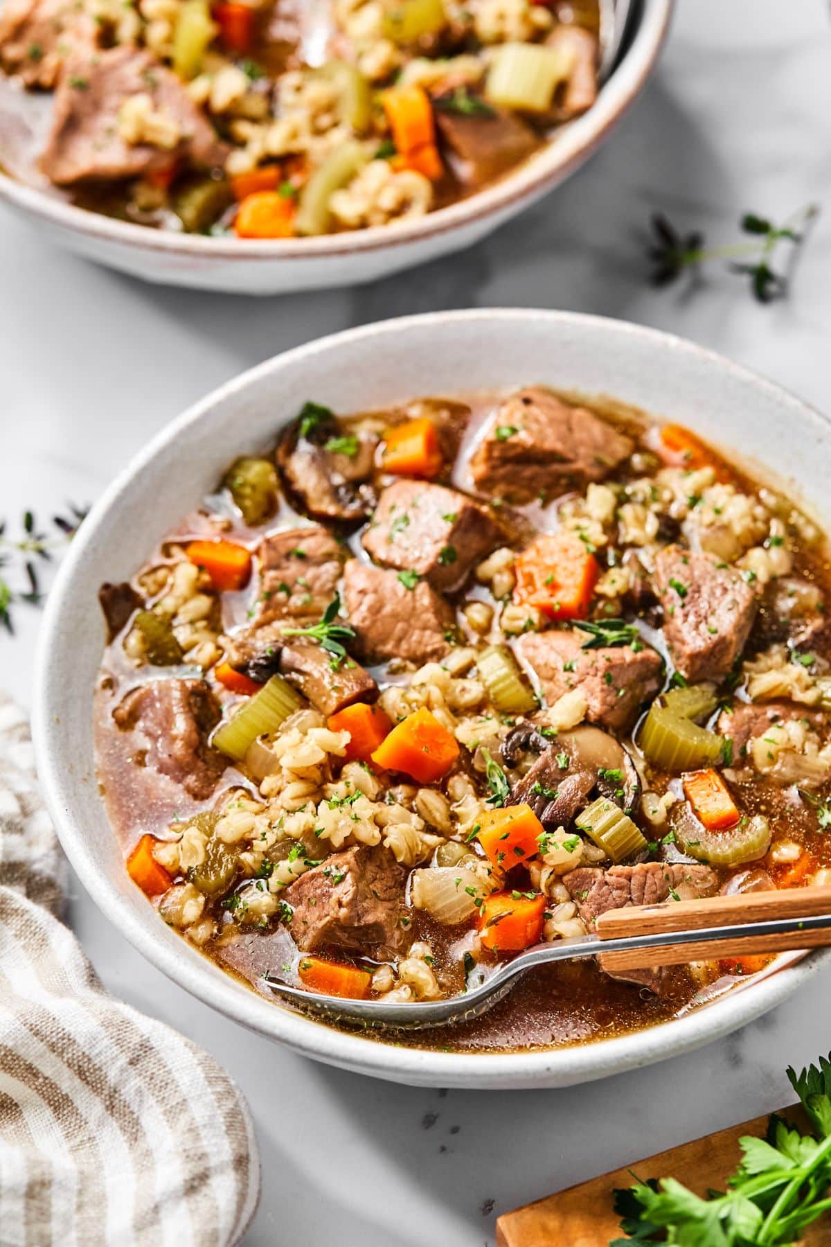 A pot full of beef and barley soup.