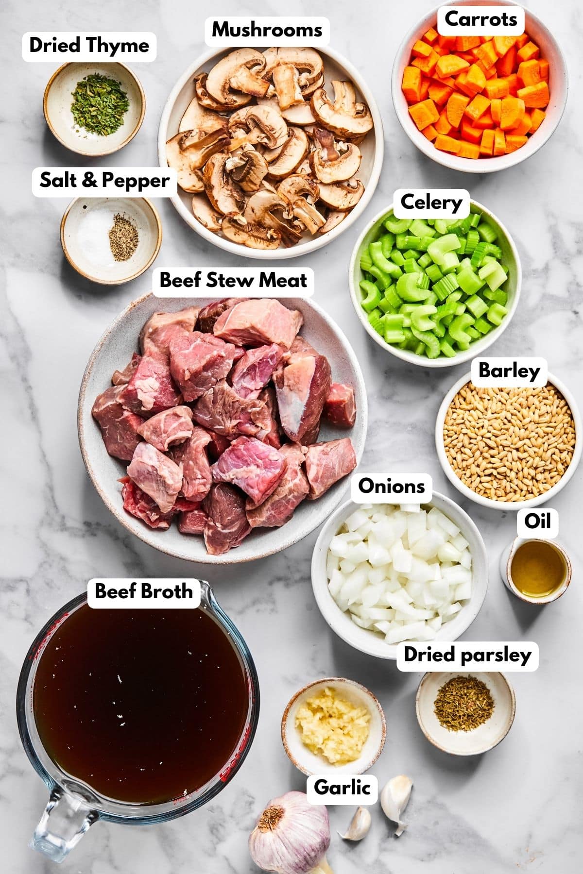 Ingredients for making beef and barley soup in bowls.