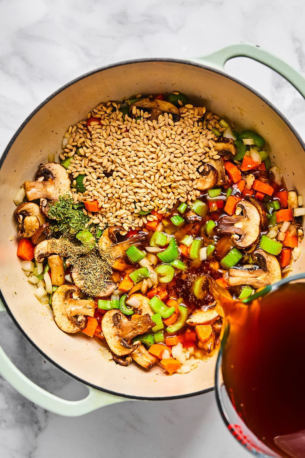 Barley and broth added to the pot.