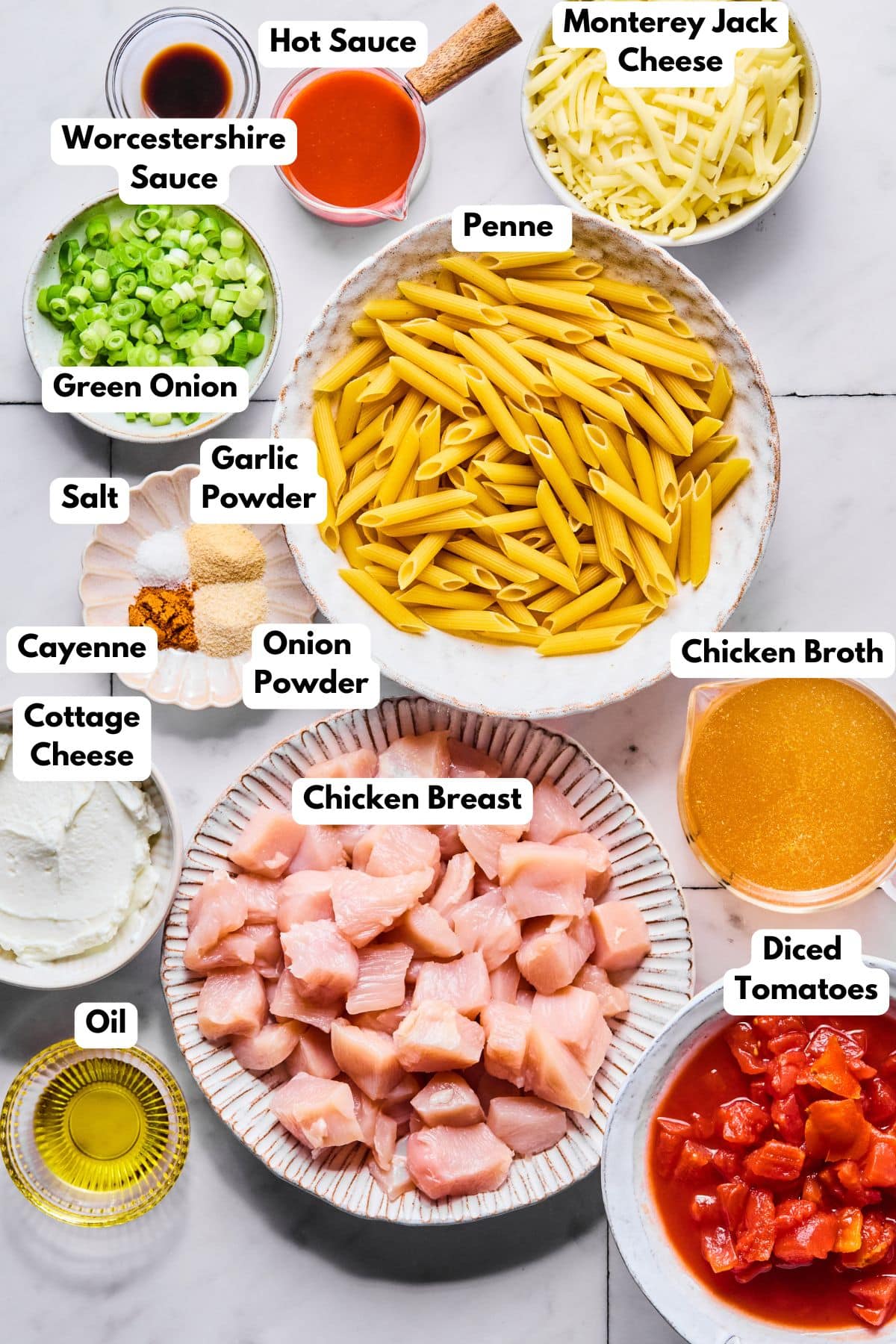 Ingredients to make buffalo chicken pasta in bowls on a table.