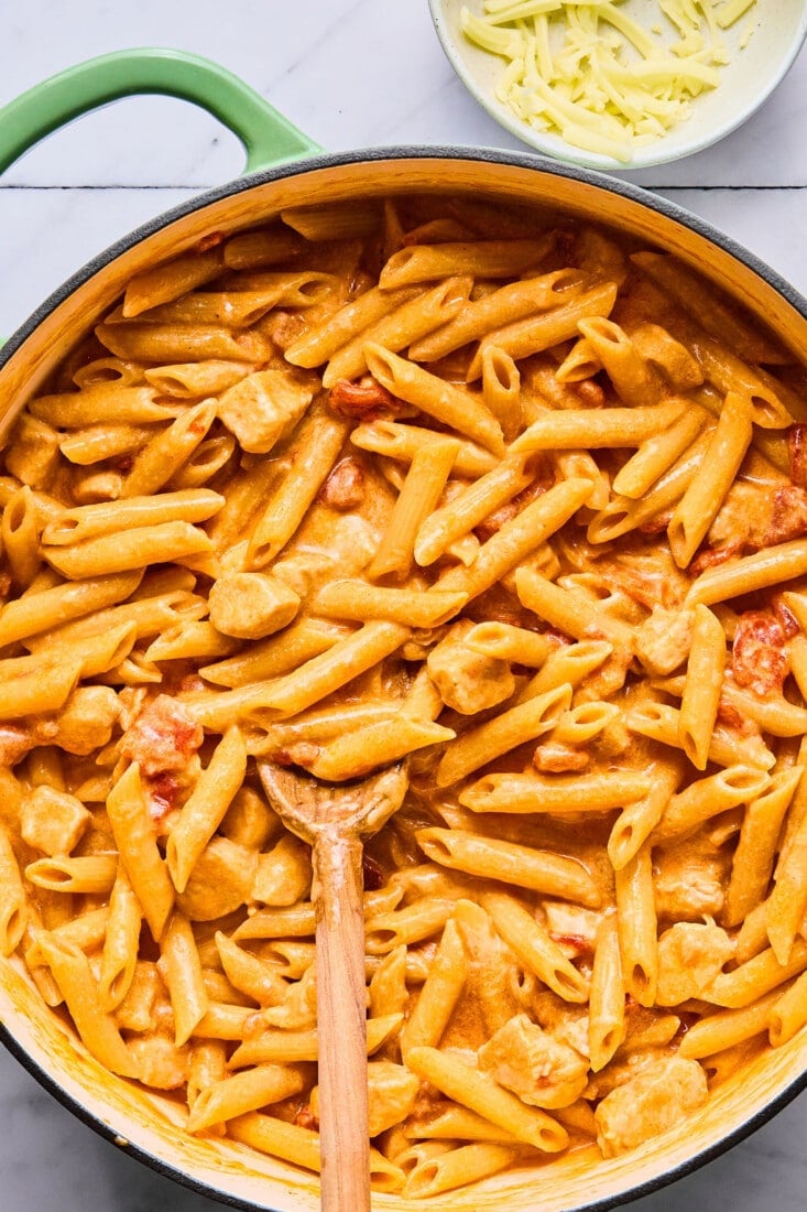 Fully cooked buffalo chicken pasta in a skillet.