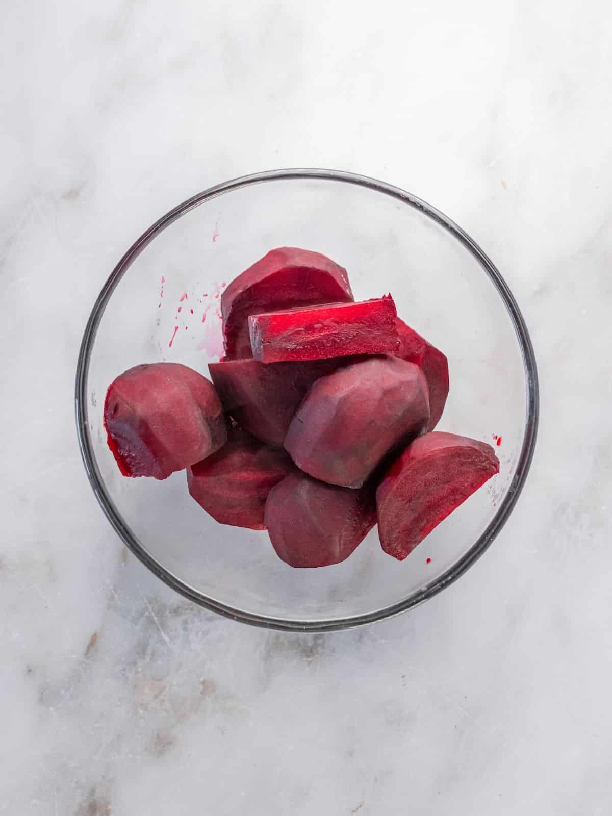 Cooked beets cut up in a bowl.