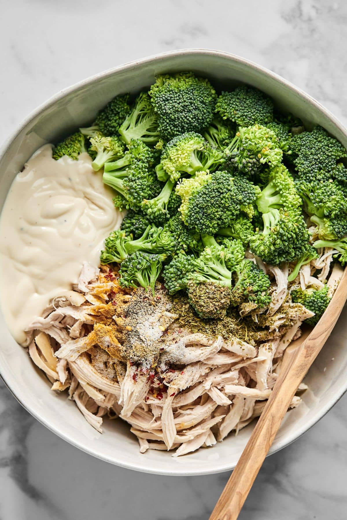Chicken, broccoli, Alfredo and spices in a bowl.