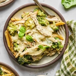 Chicken Alfredo casserole with broccoli and cheese served on a plate.