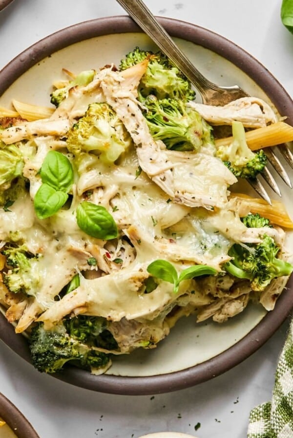Chicken Alfredo casserole with broccoli and cheese served on a plate.