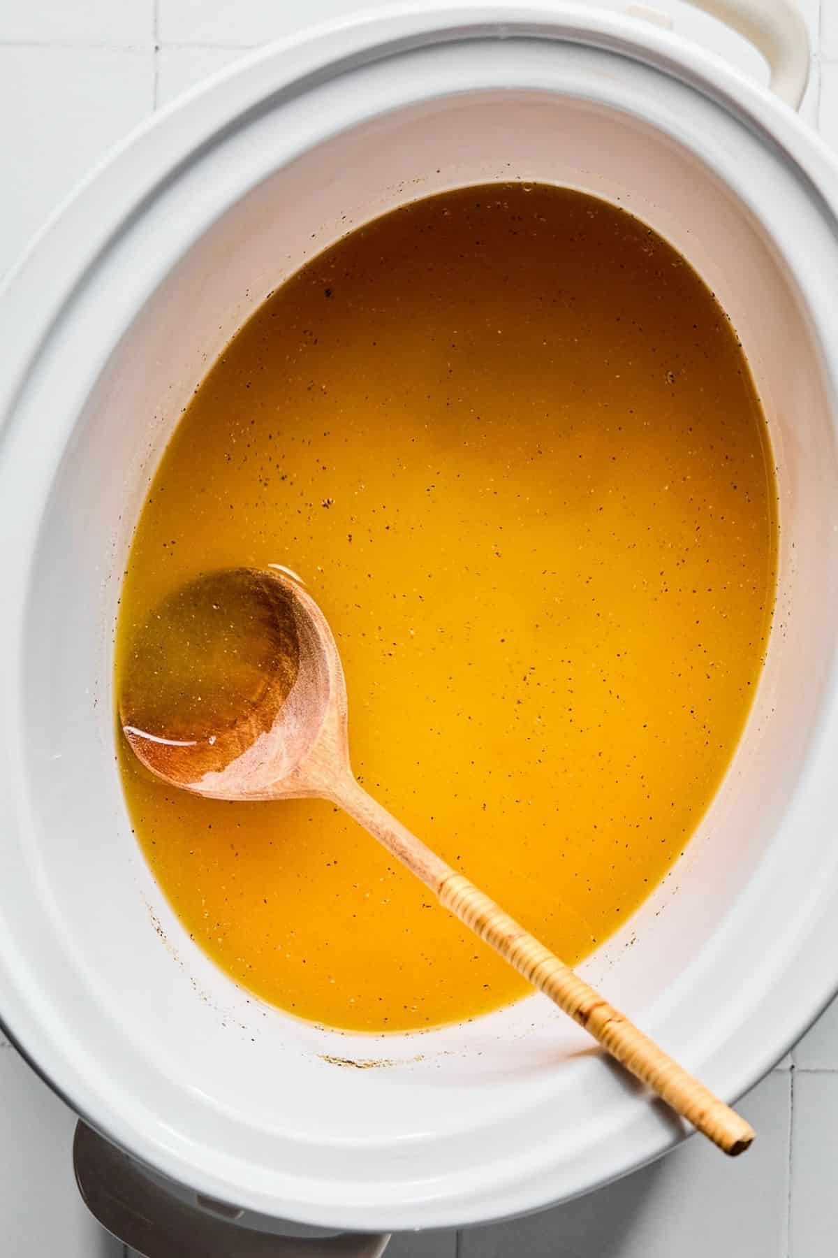 A crock pot with broth.